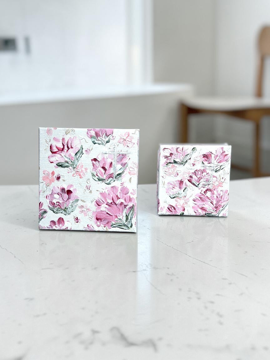 DailyLightArt set of two hand-painted floral canvases featuring textured pink blossoms on a light background.